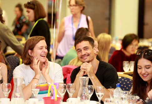 Three international students at welcome tea party