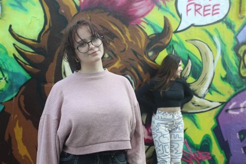 Wiktoria (left) standing in front of graffiti wall with course mate (right) in North Laines