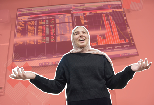 Student in a headscarf in front of a board displaying graphs