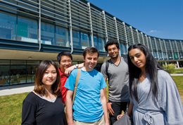 Students and staff standing in the sunshine