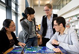 International students chatting over a map