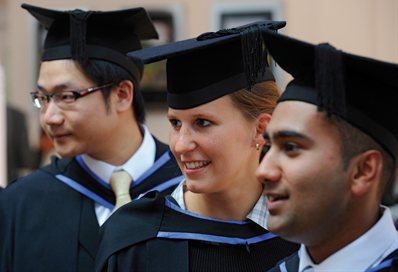 Three graduates in gowns and hats