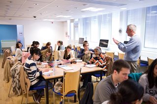 Group of students learning and working in a classroom