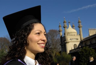 Graduate in motor board and gown by the Royal Pavilion