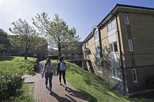 Two students walking outside university accommodation