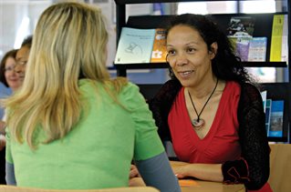 A student chatting to a member of staff