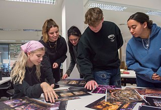 A group of art and design students working together in class