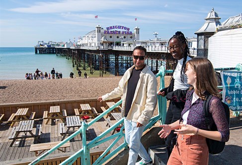 Students on Brighton seafront by the Palace Pier