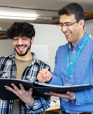 Student showing a folder of work to teacher