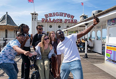 Group of students on Brighton pier taking a photo