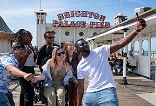 Group of students on Brighton pier taking a photo