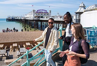 group of brighton students enjoying a sunny day at the beach 