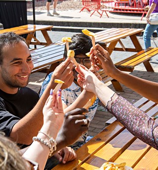 Students with chips on Brighton seafront