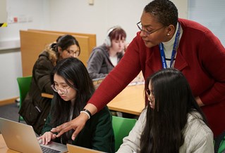 Students interacting with teacher in a class room