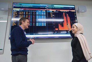 Finance student presenting to lecturer in class