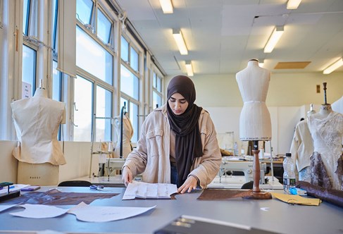 Fashion and design student working with materials in class