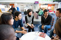 Students sitting around a table chatting