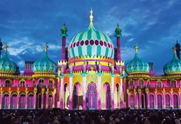 Brighton Pavilion with its Indian style facade photographed during light projection show in pink and pale green.