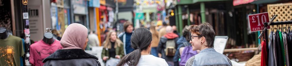 Students walking through busy narrow street