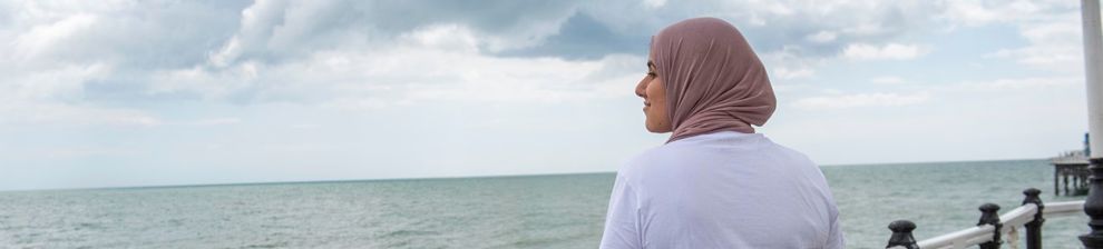 A student on Brighton pier looking out to sea