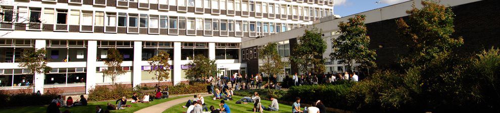 Students sitting on the grass outside the Cockcroft Building