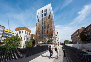 Two students walking between buildings