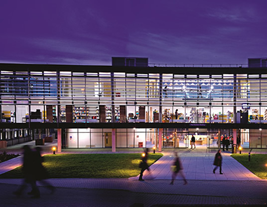 The Checkland Building on the Falmer campus at dusk