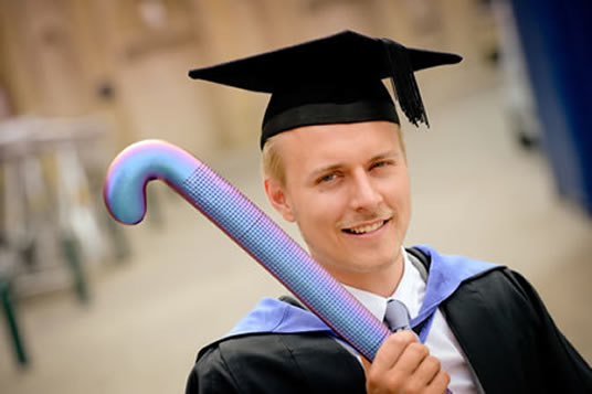 Evan Mackrill and his hockey stick at graduation