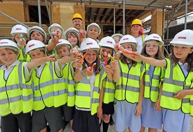 Duncan Baker-Brown and Cat Feltcher with school children and discarded toothbrushes