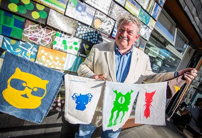 Bill Randall cutting the Waste House bunting