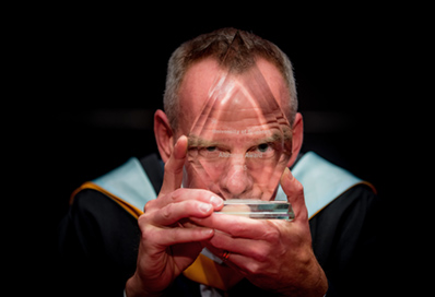 Fatboy slim holding the silver Circle of Excellence award from CASE