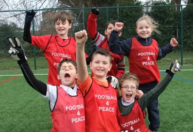 Children cheering Football 4 Peace