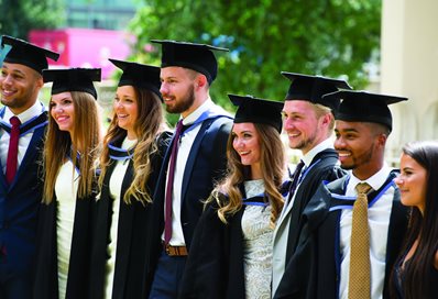 A line of graduates in gowns and mortar boards