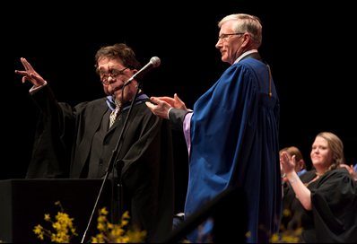 Adam receives his award from John Harvey, Chairman of the university’s Board of Governors.