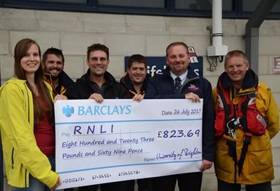 Dr Michael Williams Katharina Buerger present a cheque to Eastbourne lifeboats