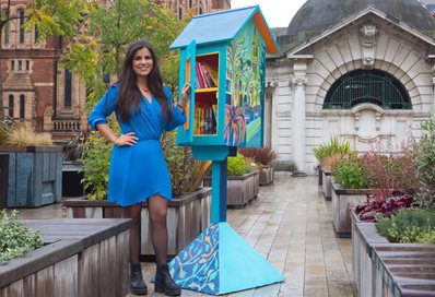 Elizabath McCarten with her bookcase painting in Mayfair, photo by Belinda Lawley