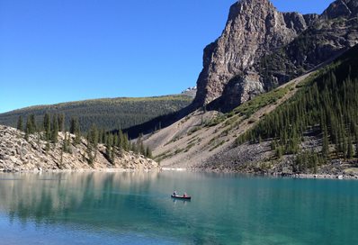 Kayak in stream by mountains