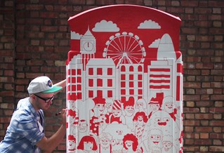 Dan Woodger drawing on a red phone box