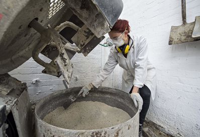 Student mixing cement