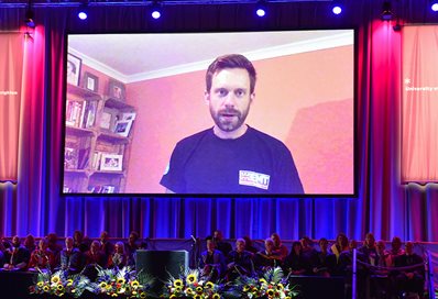 Peter Skelton on the screen at summer graduation