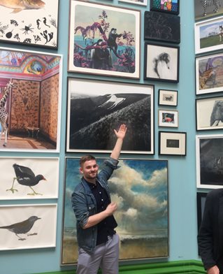 Conor pointing to his painting, top right