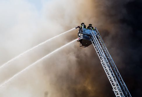 Firefighters tackling a blaze, photo by Hermes Rivera on Unsplash