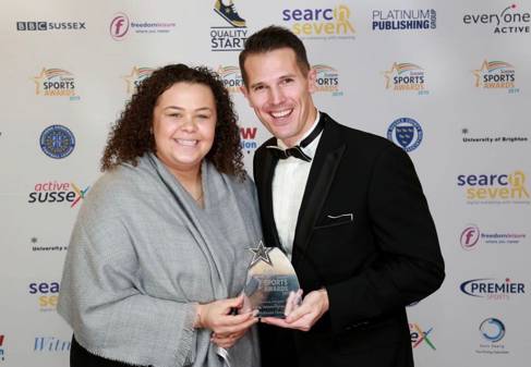 McKenzie receives her award from Barry Squires Head of Sport at the university