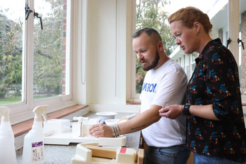 Occupational therapists working with kitchen equipment