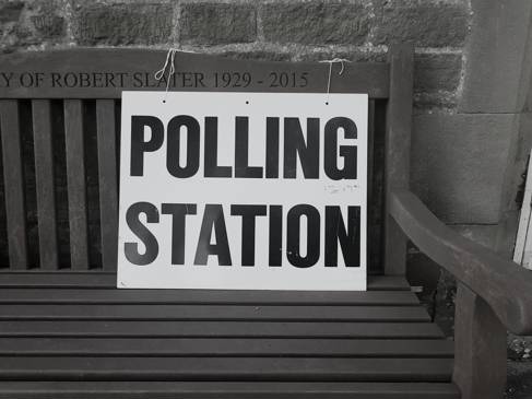 Polling Station sign placed on park bench Photo by Steve Houghton-Burnett on Unsplash