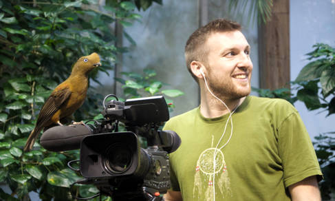 Winston Gallagher filming on location at an aviary in Germany. Photo Ann Dalimore