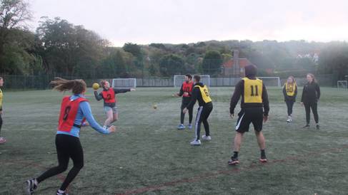 Young adults playing handball