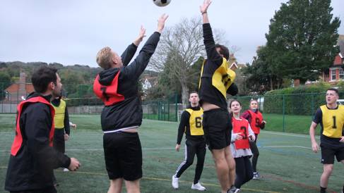 Young adults playing korfball