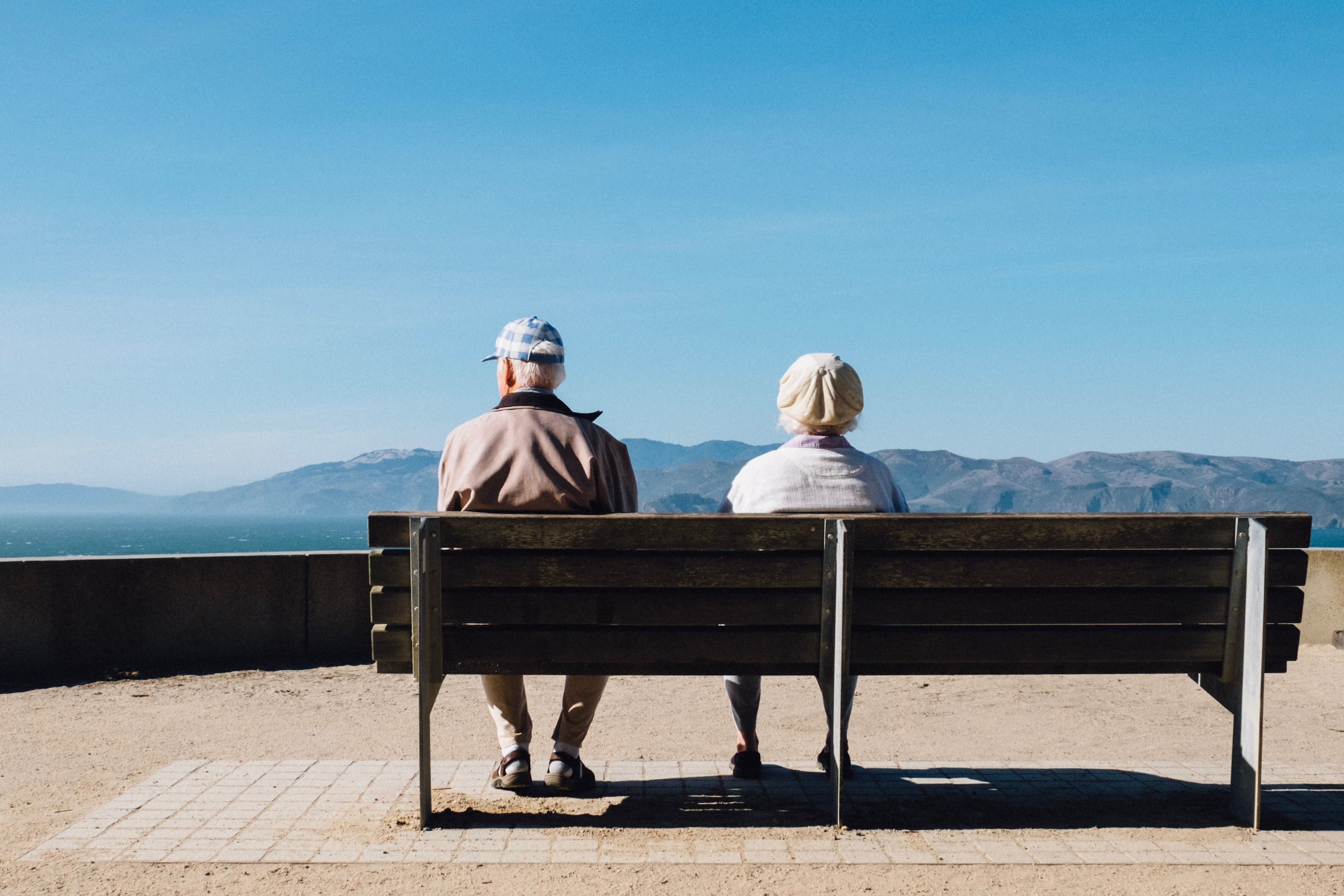Photo of elderly people sitting on bench by Matthew Bennett on Unsplash