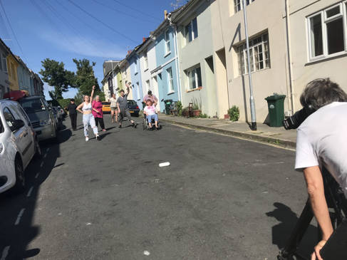 Filming a group of people in the street